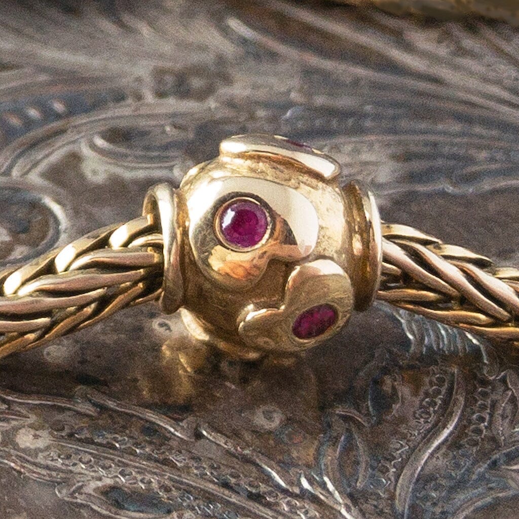 Limited Edition, 18-Karat Gold "heartbeat" Trollbead with four beautiful rubies, worn on an 18KT gold Trollbeads bracelet.