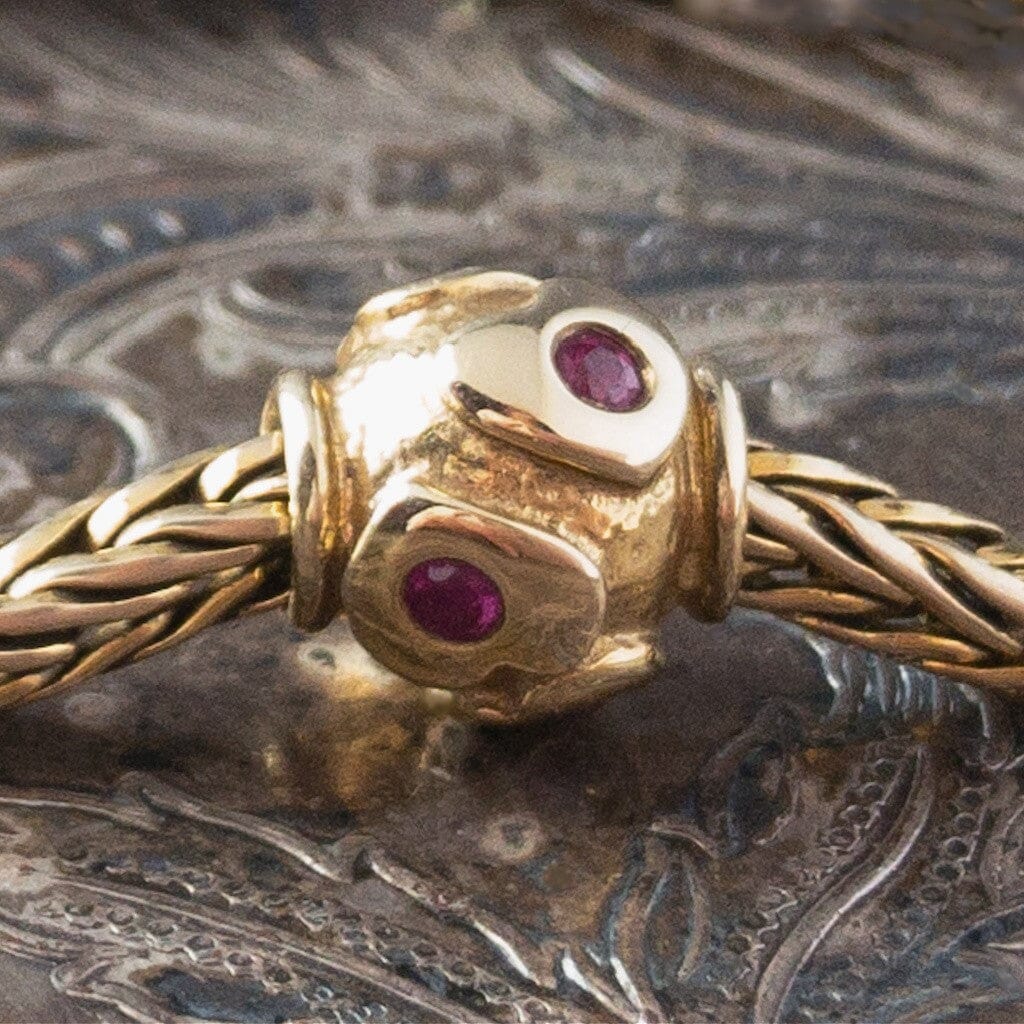 Limited Edition, 18-Karat Gold "heartbeat" Trollbead with four beautiful rubies, worn on an 18KT gold Trollbeads bracelet.