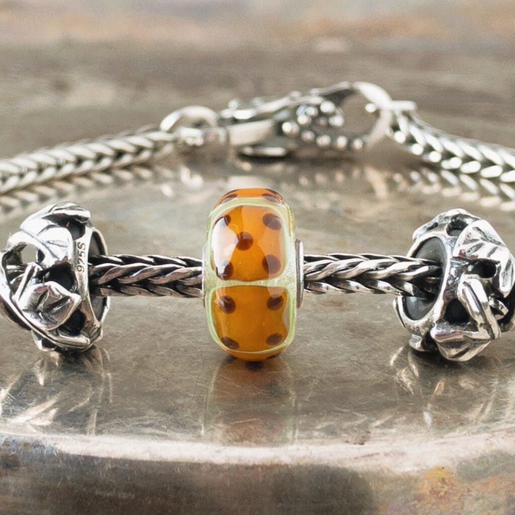 Are you feeling lucky that you found this OOAK Trollbeads Uniques "Dice" Bead at Suzie Q Studio? You probably should be because this original "textured" version is very rare. The "Dice" Uniques bead has the six faces of a die. It's a very fun and highly sought after bead, so don't let this lucky find pass you by!